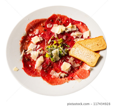 Carpaccio and cheese served on plate. Dish made of raw beef meat closeup 117434928