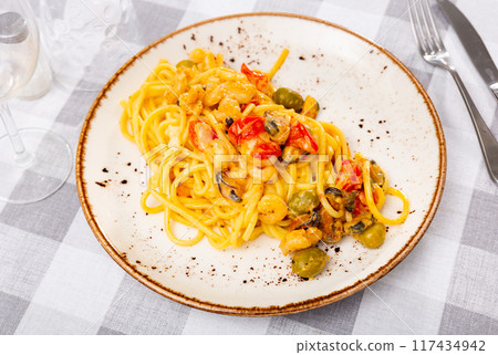 Pasta macaroni with seafood contains tiger prawns, shell mussels, spices and white sauce 117434942