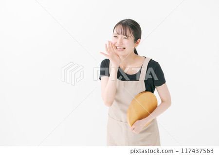 A woman in an apron calling out 117437563