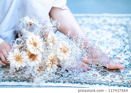 Bouquet of flowers and a woman's feet [part cut] 117437884