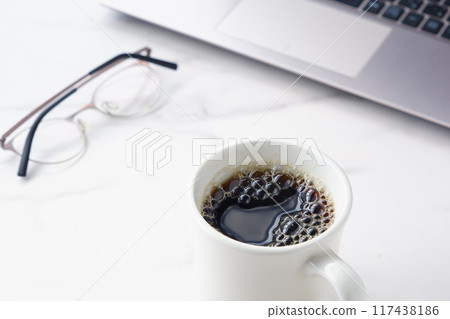 An image of someone enjoying a coffee break with freshly brewed coffee between desk work on a laptop An image of someone enjoying a coffee break with freshly brewed coffee between desk work on a laptop 117438186