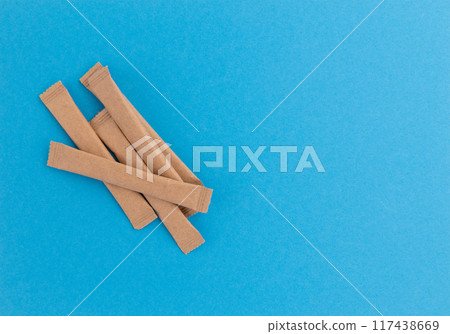 sugar packets on blue background, top view sugar packets on blue background, top view 117438669