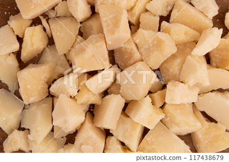 pieces of parmesan cheese as background, close up 117438679