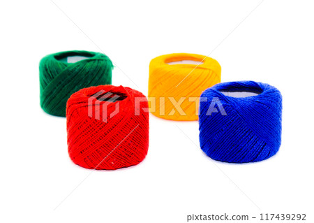A picture of thread spools isolated on white background A picture of thread spools isolated on white background 117439292