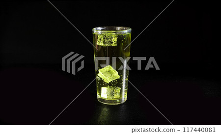 Lemonade with Rising Bubbles and Ice Cubes in Glass on a Black Background Lemonade with Rising Bubbles and Ice Cubes in Glass on a Black Background 117440081