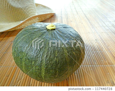 A photo of a pumpkin and a sun hat harvested from a home garden on a summer morning A photo of a pumpkin and a sun hat harvested from a home garden on a summer morning 117440728