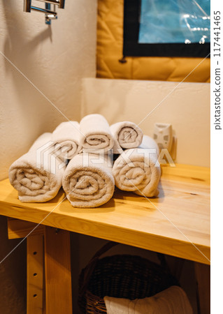 Hand and body towels rolled up by the washstand. Hand and body towels rolled up by the washstand. 117441465