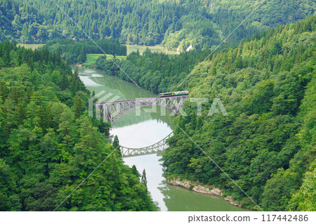 JR Tadami Line train, beautiful pond and iron bridge 117442486