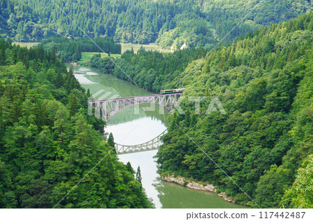 JR Tadami Line train, beautiful pond and iron bridge 117442487