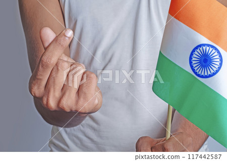 Man holding Indian flag with Korean mini heart gesture in front of body on white background. 117442587