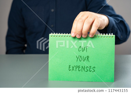 Notes Cut your expenses. Money management and budget planning. A man holds a note in his hands with an inscription. 117443155