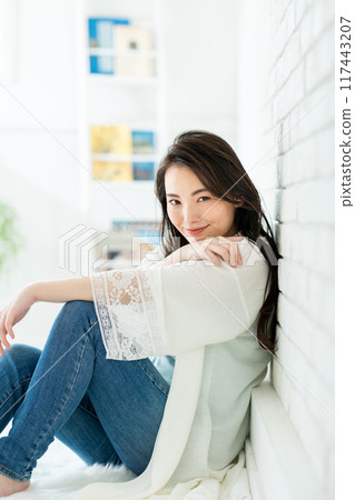 Woman sitting on the floor, portrait Woman sitting on the floor, portrait 117443207