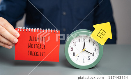 Ultimate mortgage checklist concept. Comprehensive guide outlining all the essential steps and documents for securing a mortgage. Notes in the hand of a businessman. Business and finance 117443534