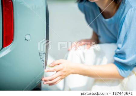 A woman who has scratched her car, a woman driving a car, a woman going for a drive A woman who has scratched her car, a woman driving a car, a woman going for a drive 117443671