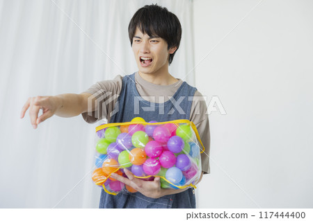 A male nursery teacher with a toy 117444400