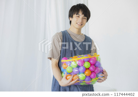 A male nursery teacher with a toy 117444402