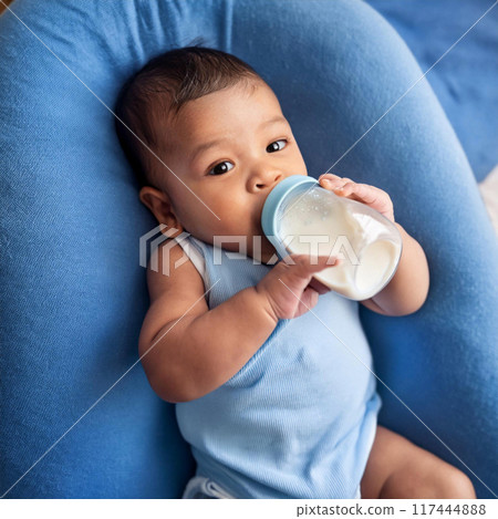 baby drinking milk on his own 117444888