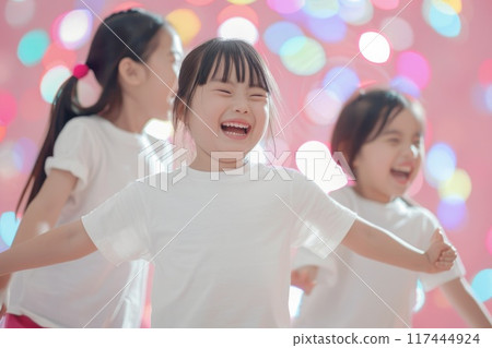 Joyful Children Laughing and Playing Against a Colorful Background Joyful Children Laughing and Playing Against a Colorful Background 117444924
