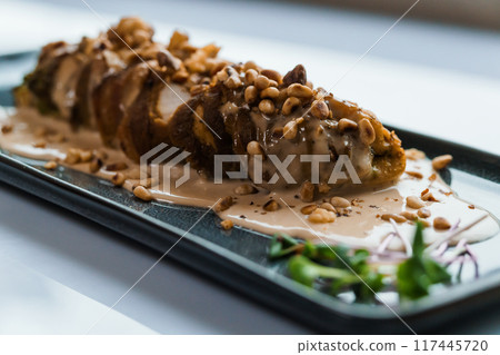 Stewed meat in mushroom sauce and herbs on a white plate Stewed meat in mushroom sauce and herbs on a white plate 117445720