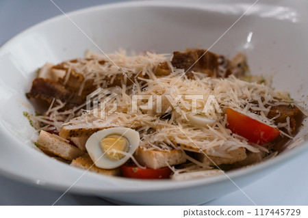 Caesar salad with chicken on a white plate Caesar salad with chicken on a white plate 117445729