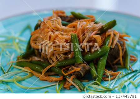 Meat stew with carrots and green beans asparagus on a plate Meat stew with carrots and green beans asparagus on a plate 117445781