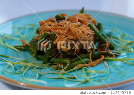 Meat stew with carrots and green beans asparagus on a plate Meat stew with carrots and green beans asparagus on a plate 117445789