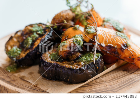 Chicken kebab with grilled vegetables on a wooden board 117445888
