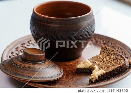 Red borscht in a pan with lard and green onions 117445890