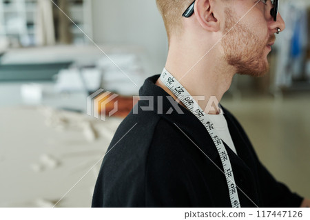 Young male tailor in black blazer 117447126