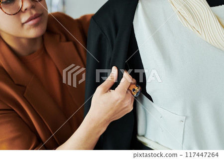 Young female tailor creating new attire 117447264