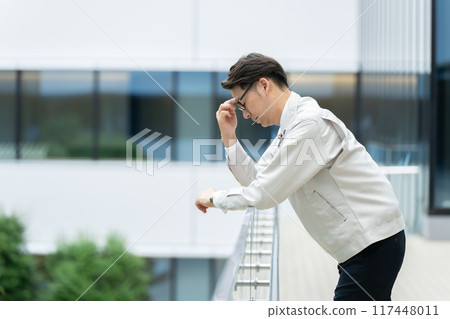 Depressed man in work clothes 117448011