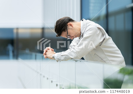 Depressed man in work clothes Depressed man in work clothes 117448019