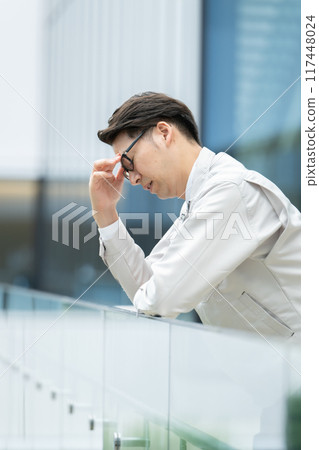 Depressed man in work clothes 117448024