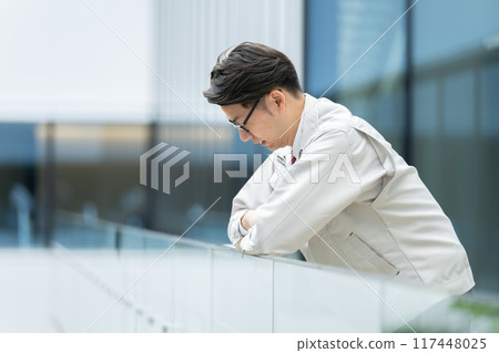 Depressed man in work clothes Depressed man in work clothes 117448025
