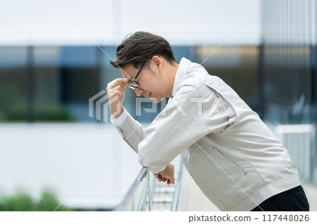 Depressed man in work clothes 117448026
