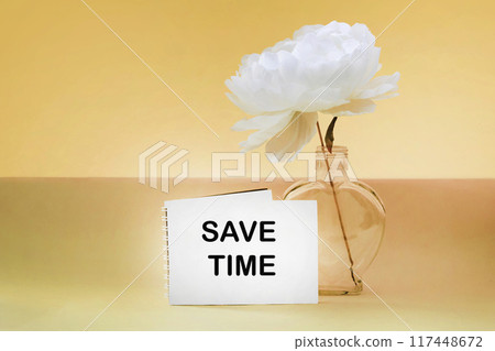 Notepad with message save time - business concept on yellow background Notepad with message save time - business concept on yellow background 117448672