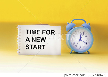 Time for a new start written on a notepad with a clock on a yellow background.New Year, Time for a new start written on a notepad with a clock on a yellow background.New Year, 117448673