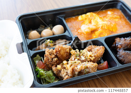 Delicious Chinese bento with chili shrimp and fried chicken 117448857