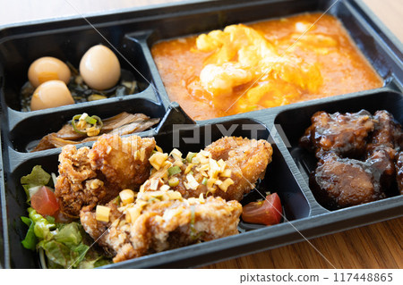Delicious Chinese bento with chili shrimp and fried chicken Delicious Chinese bento with chili shrimp and fried chicken 117448865