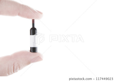 image of miniature wine bottle hand white background 117449023