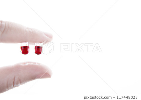 image of miniature wine glass hand white background 117449025