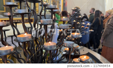Burning candles in a Catholic church during the Divine Service. Burning candles in a Catholic church during the Divine Service. 117449454