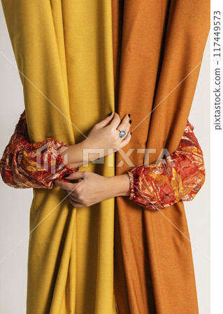 hands of a creator, carefully holding fabrics, represent the artistry involved in textile design, Autumn Elegance hands of a creator, carefully holding fabrics, represent the artistry involved in textile design, Autumn Elegance 117449573