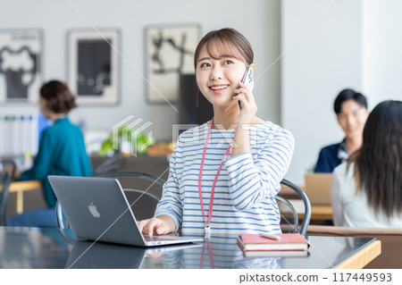 Young woman calling in the office 117449593