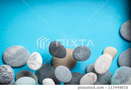 Small stones on a blue background 117449658