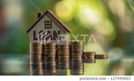 Financial concept illustration with a model of a house and a stack of coins representing mortgage and financial planning 117449891