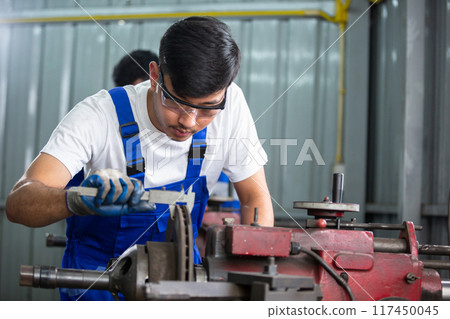 Engineering worker man wearing uniform safety working using vernier calipers Engineering worker man wearing uniform safety working using vernier calipers 117450045