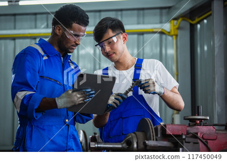 Engineering worker man using tablet working using vernier calipers measuring Engineering worker man using tablet working using vernier calipers measuring 117450049
