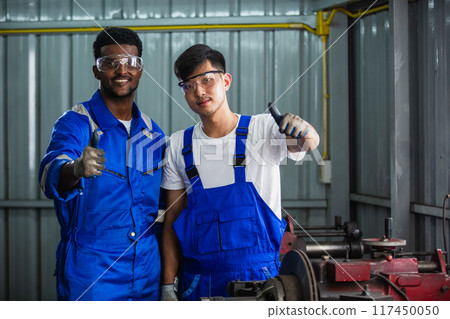 Technician team worker man wearing uniform safety working machine lathe Technician team worker man wearing uniform safety working machine lathe 117450050