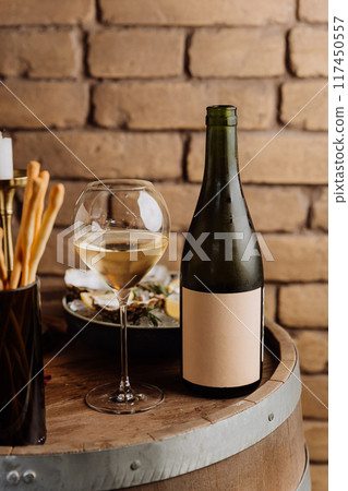 Elegant wine bottle with oysters and lemon, perfect for luxury dining and fine dining concepts 117450557